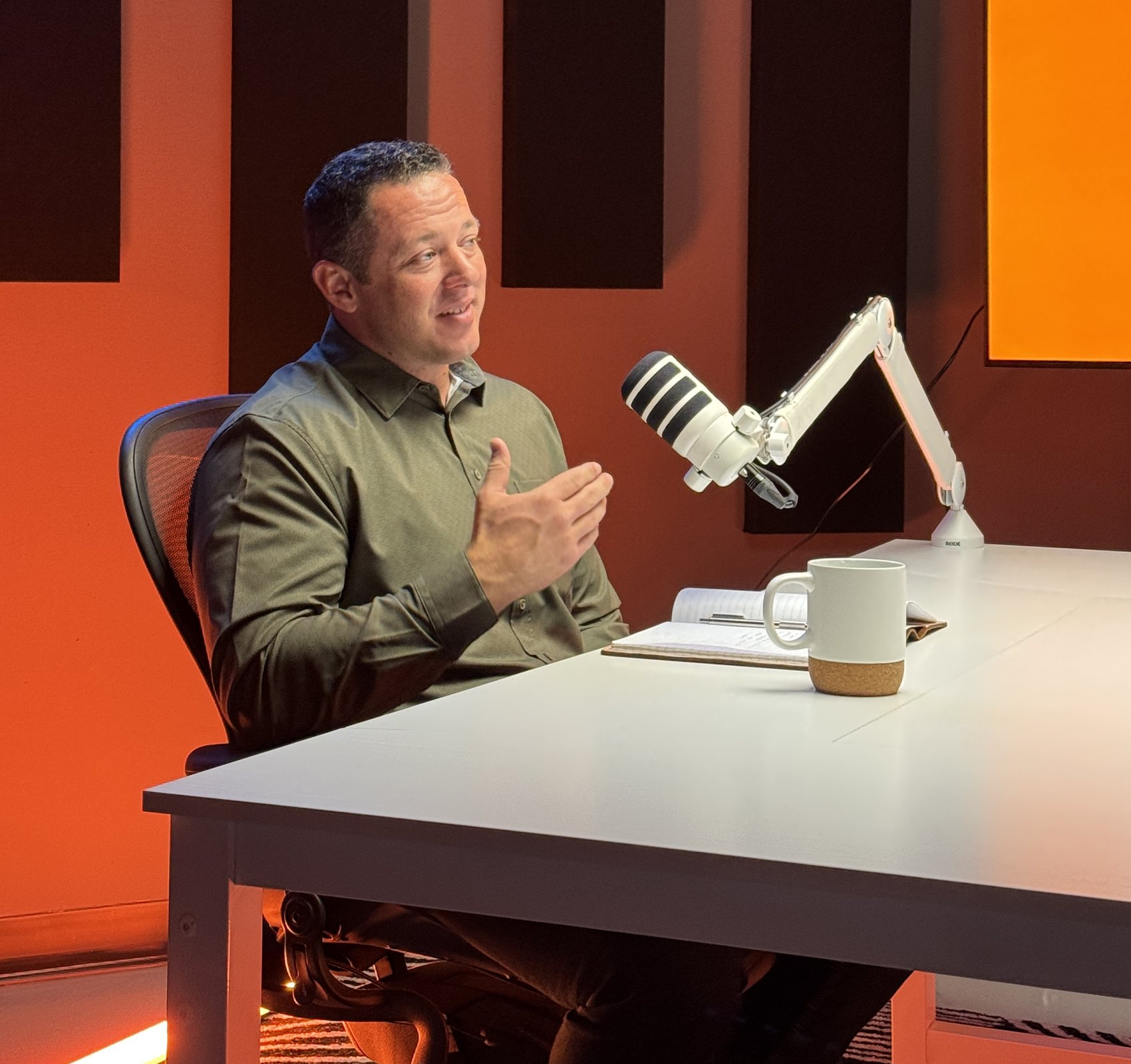 Ryan Graves recording an episode of Here to Serve in the studio